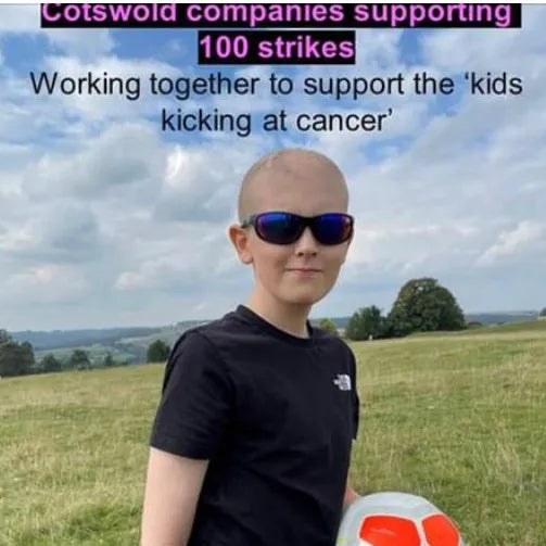 Young boy with sunglasses and a bald head standing in a field with text about Cotswold companies supporting 100 strikes for cancer research.