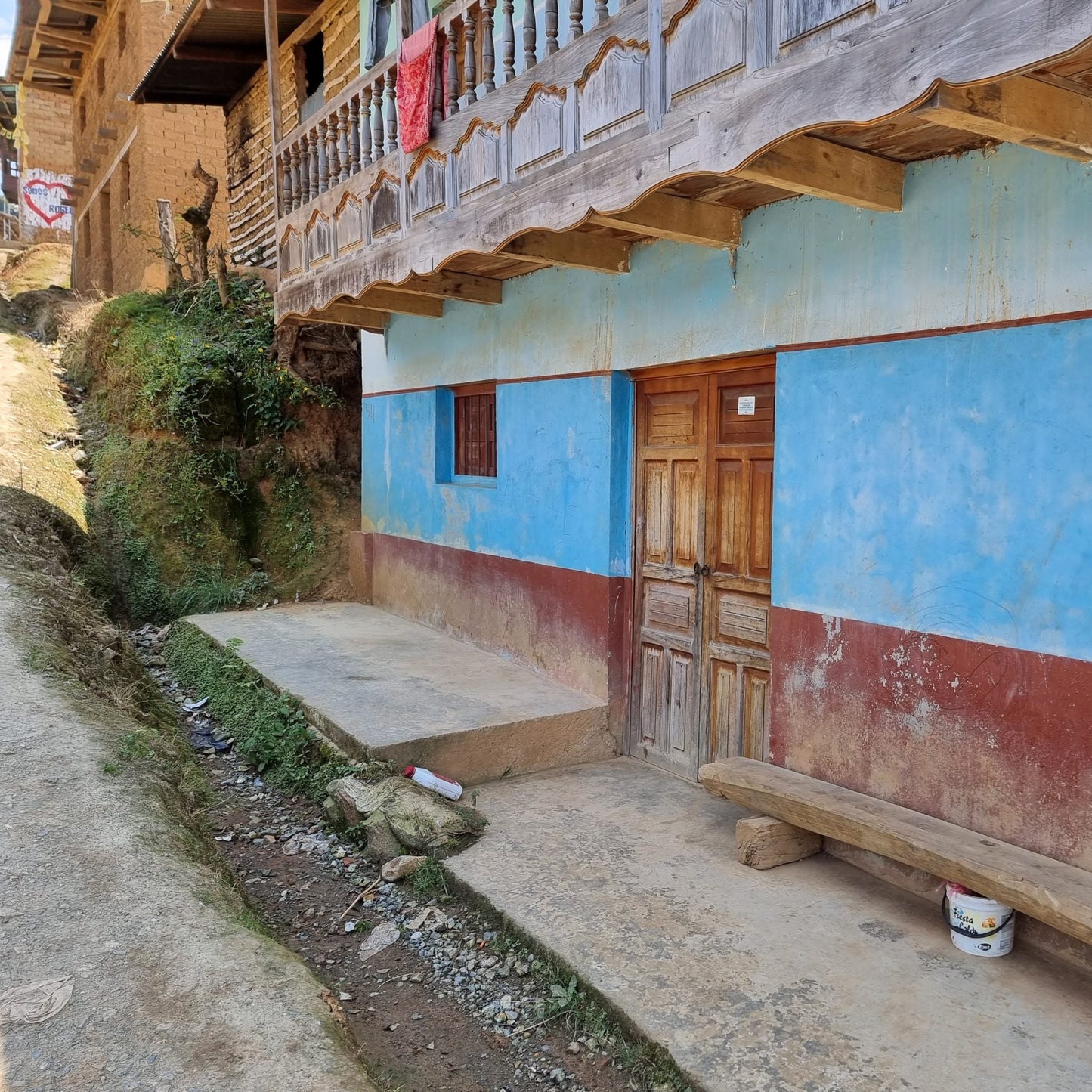 Traditional building with blue and red walls in a rural setting