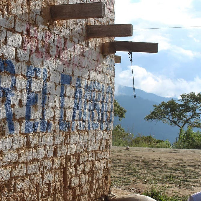 Old brick building with blue painted lettering