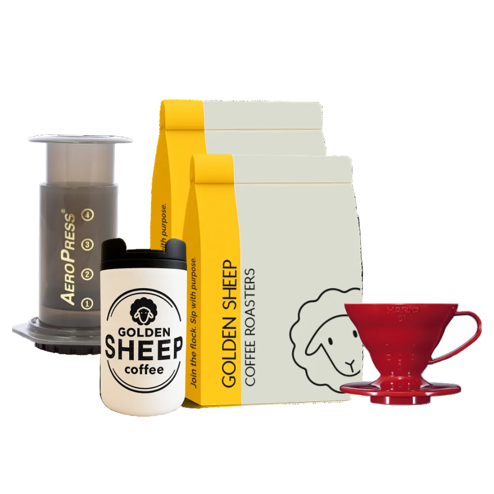 AeroPress coffee maker, Golden Sheep coffee bag, tumbler, and red coffee filter on a white background